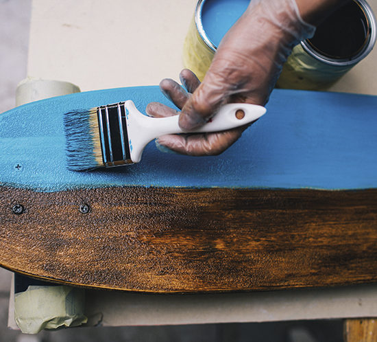 A tradesman painting furniture - Lagentium Insurance Brokers