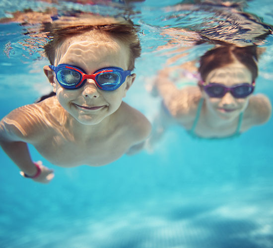Children swimming while on holiday - R Collins & Co Insurance Brokers